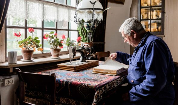 Molenaar in knusse woonkamer van Museummolen Nederwaard.