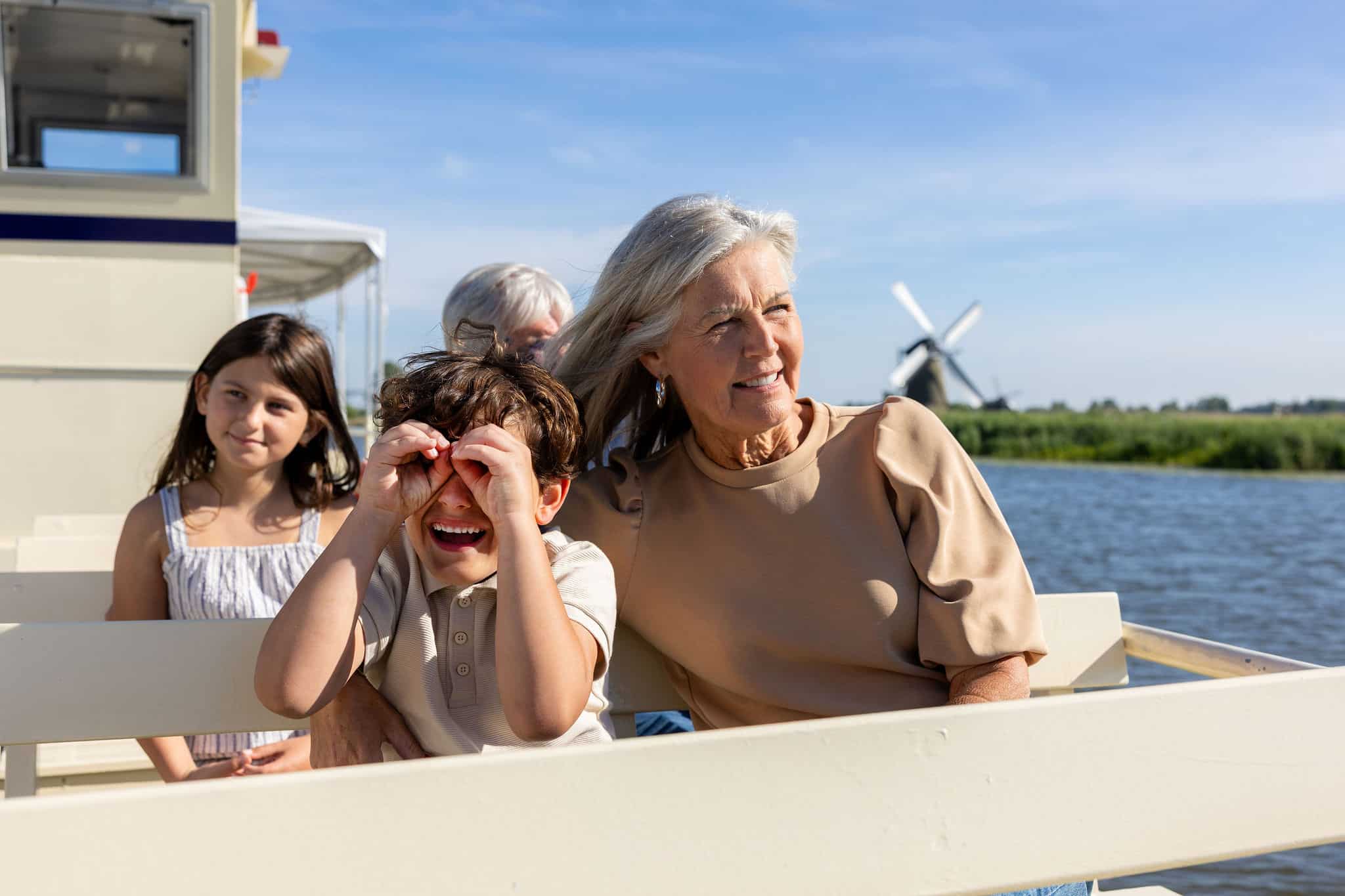 Children with grandparents using hands as binoculars