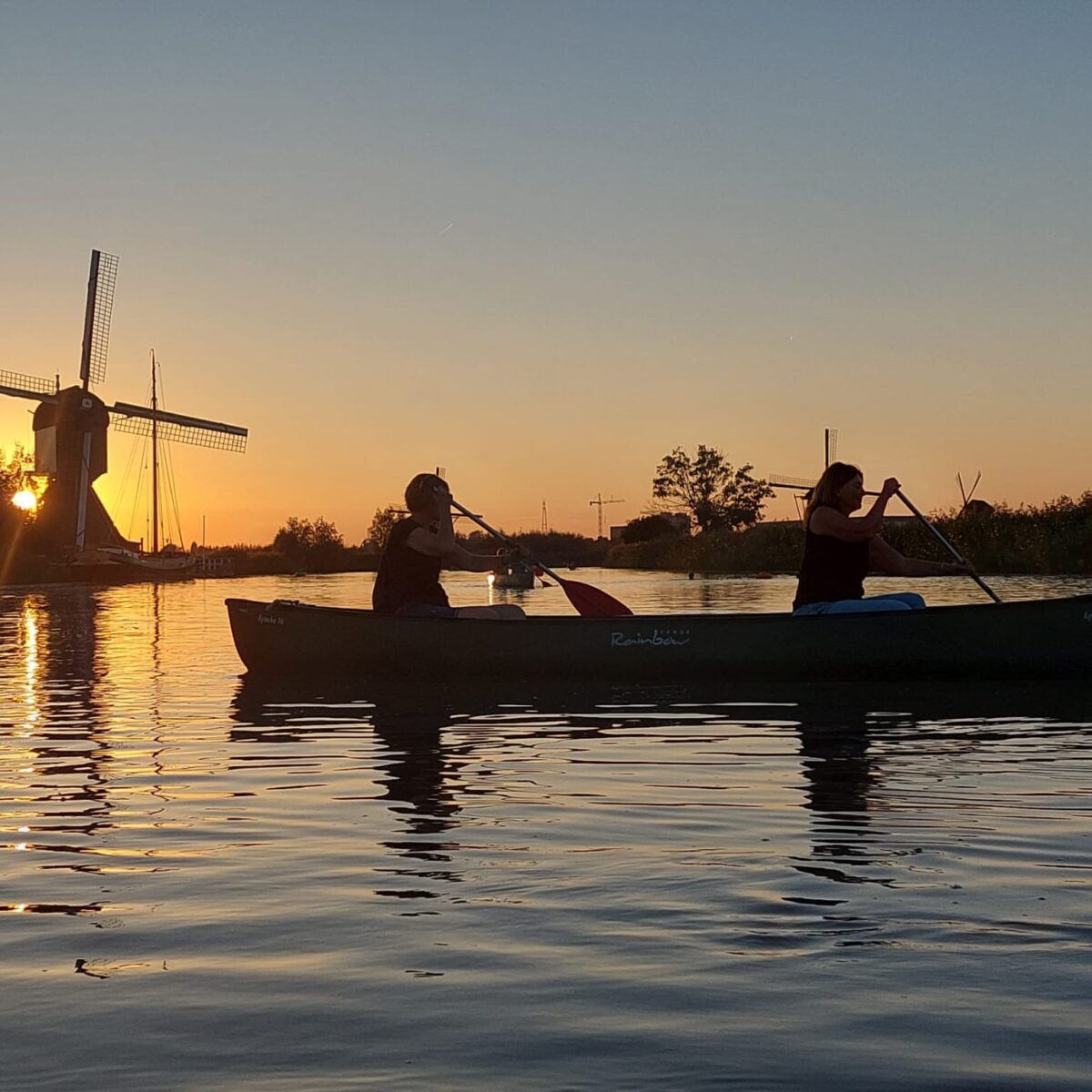 Kayaking during sunset at Illumination Week in Kinderdijk.