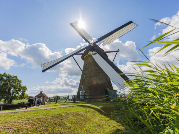 The Nederwaard Museum Mill with sails on its blades on a sunny day in Kinderdijk.